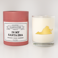 Load image into Gallery viewer, Double wicked soy candle in a 13.5 oz tumbler with the state of  Virginia printed in 22k gold foil on the face. Red cylinder packaging with In My Santa Era on the label. SEO Text â€“ Drinking glass, soy wax candle, Christmas Candle, hand poured, small batch, scented candle, Woman Owned, local candle, Housewarming present, gives back, charity, community candle, becomes a cocktail glass, closing gift. 

