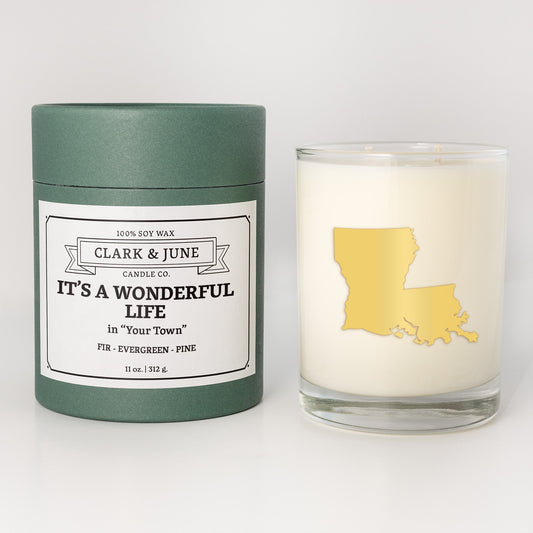 Double wicked soy candle in a 13.5 oz tumbler with the state of Louisianaprinted in 22k gold foil on the face. Green cylinder packaging with It's a Wonderful Life in "Your Town"on the label. SEO Text – Drinking glass, soy wax candle, Christmas Candle, hand poured, small batch, scented candle, Woman Owned, local candle, Housewarming present, gives back, charity, community candle, becomes a cocktail glass, closing gift. 