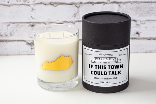 Double wicked soy candle in a 13.5 oz tumbler with the state of Kentucky printed in 22k gold foil on the face. Black cylinder packaging with “If This Town Could Talk” on the label. SEO Text – Drinking glass, soy wax candle, Kentucky candle, hand poured, small batch, scented candle, Woman Owned, local candle, Housewarming present, gives back, charity, community candle, becomes a cocktail glass, closing gift. 