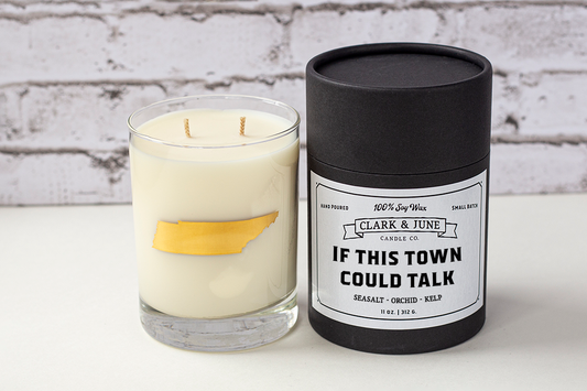Double wicked soy candle in a 13.5 oz tumbler with the state of Tennessee printed in 22k gold foil on the face. Black cylinder packaging with “If This Town Could Talk” on the label. SEO Text – Drinking glass, soy wax candle, Tennessee candle, hand poured, small batch, scented candle, Woman Owned, local candle, Housewarming present, gives back, charity, community candle, becomes a cocktail glass, closing gift.