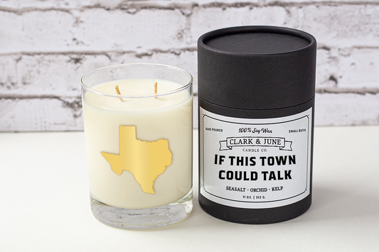 Double wicked soy candle in a 13.5 oz tumbler with the state of Texas printed in 22k gold foil on the face. Black cylinder packaging with “If This Town Could Talk” on the label. SEO Text – Drinking glass, soy wax candle, Texas candle, hand poured, small batch, scented candle, Woman Owned, local candle, Housewarming present, gives back, charity, community candle, becomes a cocktail glass, closing gift.