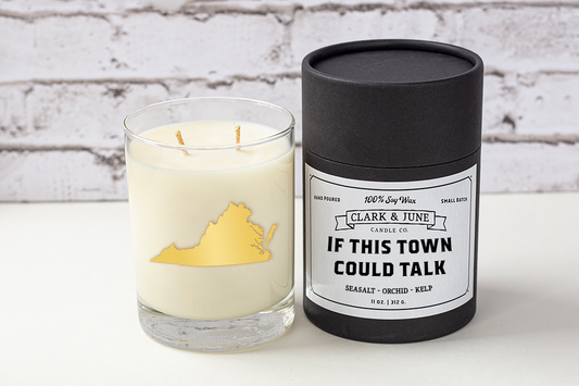 Double wicked soy candle in a 13.5 oz tumbler with the state of Virginia printed in 22k gold foil on the face. Black cylinder packaging with “If This Town Could Talk” on the label. SEO Text – Drinking glass, soy wax candle, Virginia candle, hand poured, small batch, scented candle, Woman Owned, local candle, Housewarming present, gives back, charity, community candle, becomes a cocktail glass, closing gift.
