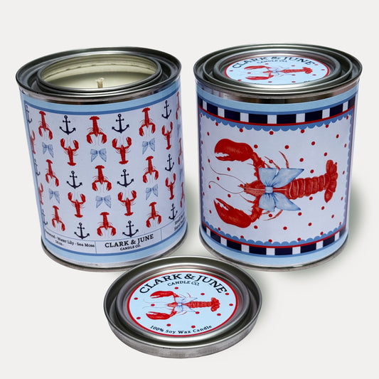 14oz Lobster design soy wax candle in a pint sized paint can made by Clark & June Candle Co. The candle is wrapped with a blue, white  and red label showing a repeating pattern of red lobsters and blue anchors and bows on the back and a lobster with a bow surrounded by polka dots on the front. The scent is Rosewood – Water Lilly – Sea Moss and was hand poured in small batches. 

Lobster Candle, Scented Candle, Paint Can Candle. Single Cotton Wick, Fish Core
