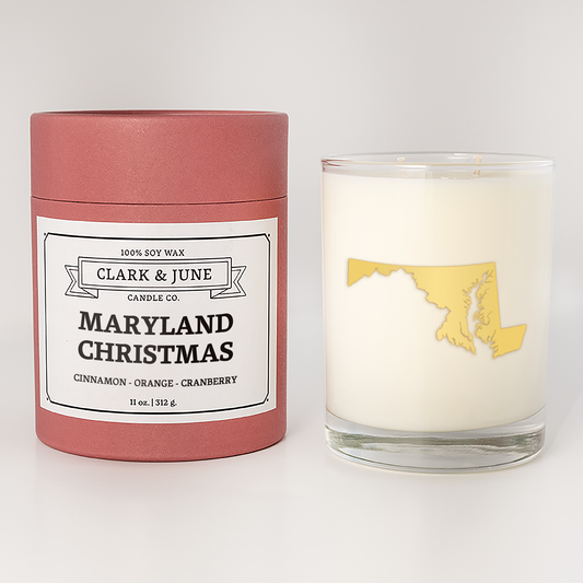 Double wicked soy candle in a 13.5 oz tumbler with the state of  Maryland printed in 22k gold foil on the face. Red cylinder packaging with Maryland Christmas on the label. SEO Text â€“ Drinking glass, soy wax candle, Christmas Candle, hand poured, small batch, scented candle, Woman Owned, local candle, Housewarming present, gives back, charity, community candle, becomes a cocktail glass, closing gift. 
