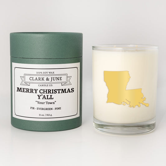 Double wicked soy candle in a 13.5 oz tumbler with the state of Louisianaprinted in 22k gold foil on the face. Green cylinder packaging with Merry Christmas Y'All "Your Town"on the label. SEO Text – Drinking glass, soy wax candle, Christmas Candle, hand poured, small batch, scented candle, Woman Owned, local candle, Housewarming present, gives back, charity, community candle, becomes a cocktail glass, closing gift. 