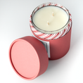 Load image into Gallery viewer, Double wicked soy wax candle inside of red holiday packaging 
