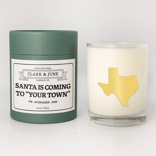 Double wicked soy candle in a 13.5 oz tumbler with the state of Texasprinted in 22k gold foil on the face. Green cylinder packaging with Santa is Coming to "Your Town"on the label. SEO Text – Drinking glass, soy wax candle, Christmas Candle, hand poured, small batch, scented candle, Woman Owned, local candle, Housewarming present, gives back, charity, community candle, becomes a cocktail glass, closing gift. 