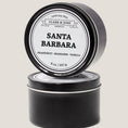 Load image into Gallery viewer, Single wicked 8oz candle in a black finish with “North Carolina” on the label. SEO Text –soy wax candle, Alabama candle, hand poured, small batch, scented candle, Woman Owned, local candle, Housewarming present, gives back, charity, community candle, closing gift. 

