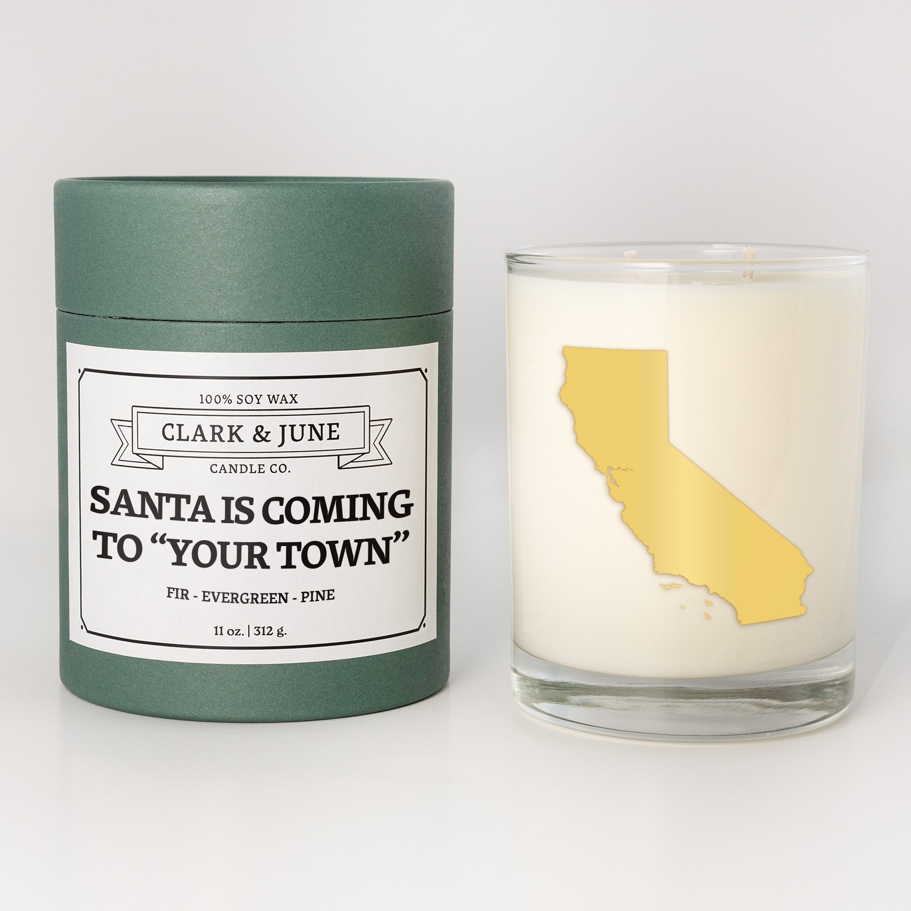 Double wicked soy candle in a 13.5 oz tumbler with the state of  California printed in 22k gold foil on the face. Green cylinder packaging with Santa is Coming to "Your Town" on the label. SEO Text â€“ Drinking glass, soy wax candle, Christmas Candle, hand poured, small batch, scented candle, Woman Owned, local candle, Housewarming present, gives back, charity, community candle, becomes a cocktail glass, closing gift. 
