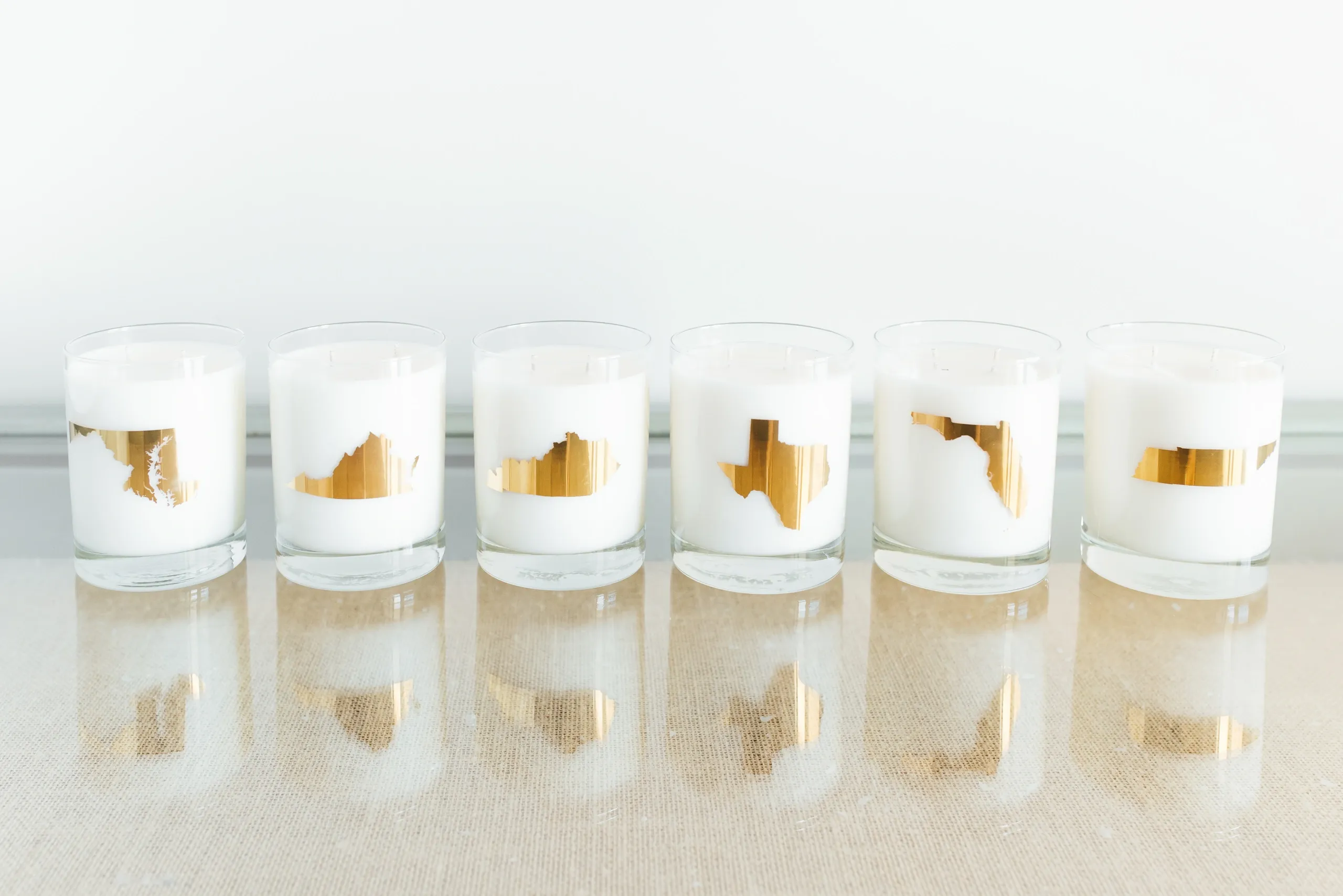 Collection of rocks glasses with state logos in 22k Gold MD, VA, KY, TX, FL, TN