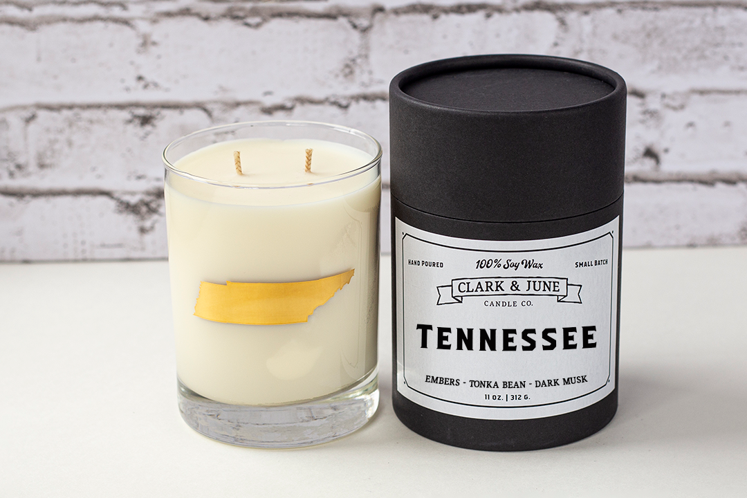 Double wicked soy candle in a 13.5 oz tumbler with the state of Tennessee printed in 22k gold foil on the face. Black cylinder packaging with “Tennessee” on the label. SEO Text – Drinking glass, soy wax candle, Tennessee candle, hand poured, small batch, scented candle, Woman Owned, local candle, Housewarming present, gives back, charity, community candle, becomes a cocktail glass, closing gift.