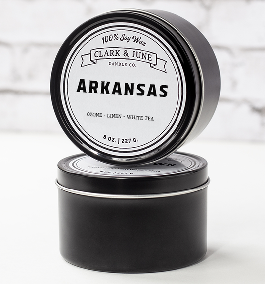 Single wicked 8oz candle in a black finish with “Arkansas” on the label. SEO Text –soy wax candle, Alabama candle, hand poured, small batch, scented candle, Woman Owned, local candle, Housewarming present, gives back, charity, community candle, closing gift. 