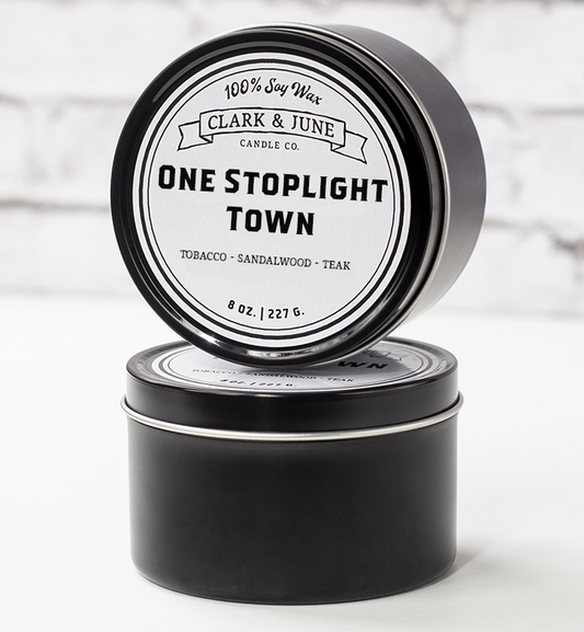 Single wicked 8oz candle in a black finish with “One Stoplight Town” on the label. SEO Text –soy wax candle, Alabama candle, hand poured, small batch, scented candle, Woman Owned, local candle, Housewarming present, gives back, charity, community candle, closing gift. 