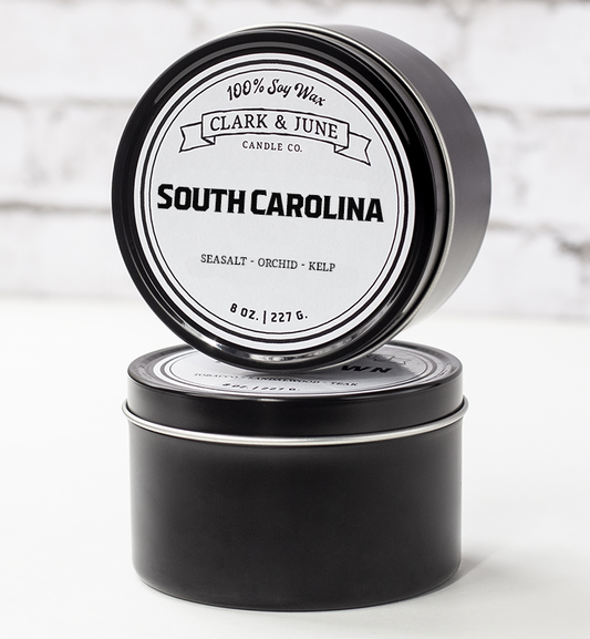 Single wicked 8oz candle in a black finish with “South Carolina” on the label. SEO Text –soy wax candle, Alabama candle, hand poured, small batch, scented candle, Woman Owned, local candle, Housewarming present, gives back, charity, community candle, closing gift. 