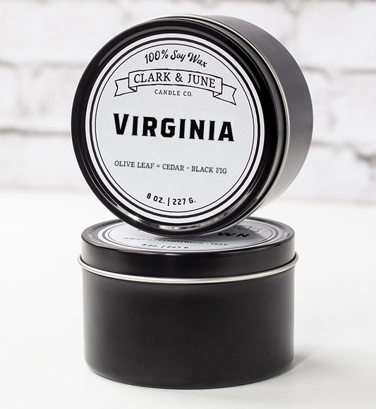 Single wicked 8oz candle in a black finish with "Virginia" on the label. SEO Text –soy wax candle, Alabama candle, hand poured, small batch, scented candle, Woman Owned, local candle, Housewarming present, gives back, charity, community candle, closing gift. 